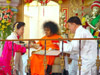 Bhagawan blessing devotees and accepting their traditional gifts given during the occasion
