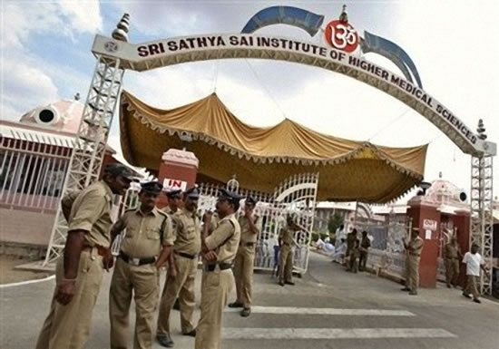 Indian policemen are deployed outside the Sri Satya Sai Institute of Higher Medical Sciences, where the revered Hindu holy man Sathya Sai Baba is undergoing treatment at Puttaparti, about 450 kilometers (281 miles) from Hyderabad, India, Thursday, April 21, 2011. The 84-year-old guru was hospitalized early this month for lung and chest congestion. A hospital statement on Thursday said he was critical and is poorly responding to the medicine.